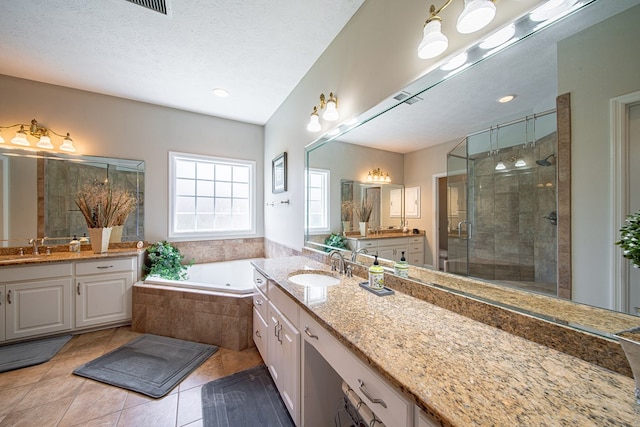8039 Adelaide Dr, Columbus, GA 31909 - full bath with a stall shower, tile patterned floors, a garden tub, and two vanities