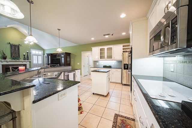 8039 Adelaide Dr, Columbus, GA 31909 - kitchen with appliances with stainless steel finishes, a sink, a fireplace, a spacious island, and decorative backsplash
