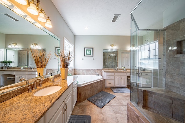 8039 Adelaide Dr, Columbus, GA 31909 - bathroom featuring a shower stall, a bath, tile patterned floors, and two vanities