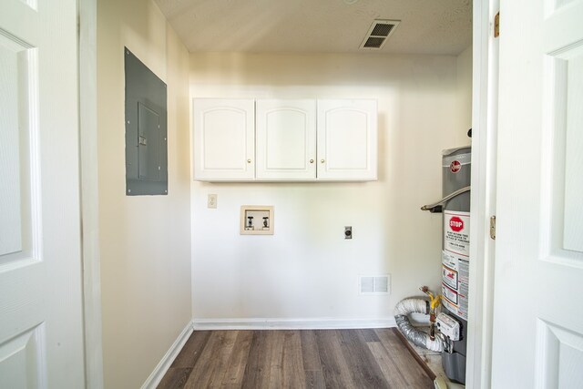 clothes washing area with strapped water heater, hookup for an electric dryer, dark hardwood / wood-style flooring, electric panel, and hookup for a washing machine