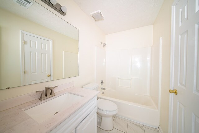 full bathroom featuring vanity, tile patterned floors, shower / washtub combination, toilet, and a textured ceiling