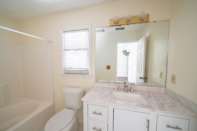 full bathroom with shower / tub combination, vanity, and toilet