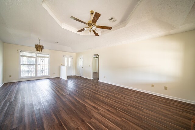 unfurnished living room featuring a raised ceiling, dark hardwood / wood-style flooring, and a textured ceiling