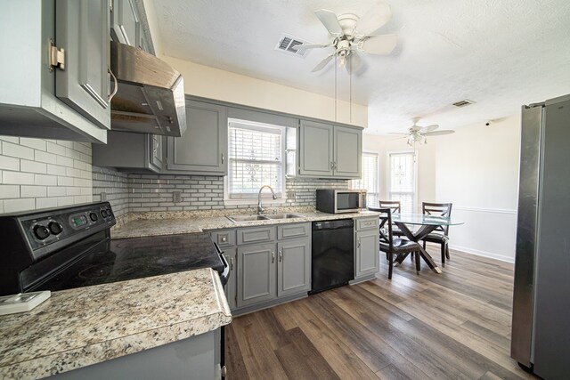 kitchen featuring black appliances, gray cabinetry, sink, and dark wood-type flooring