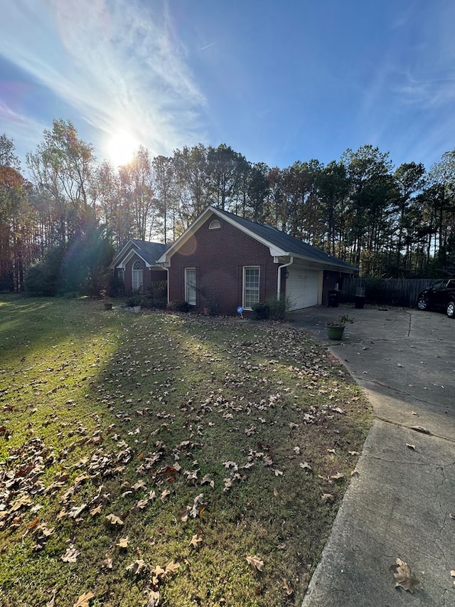 view of side of property with a yard and a garage