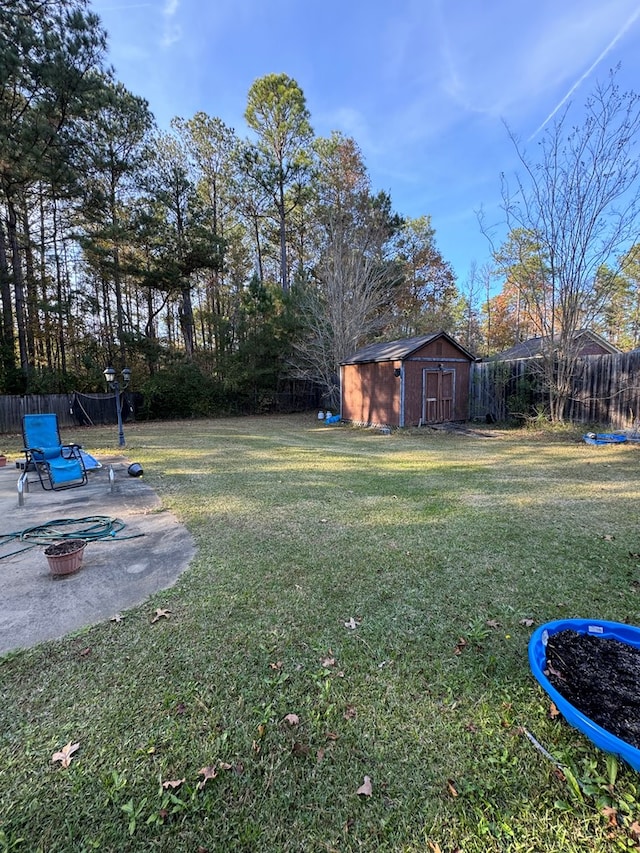 view of yard featuring a shed and a patio