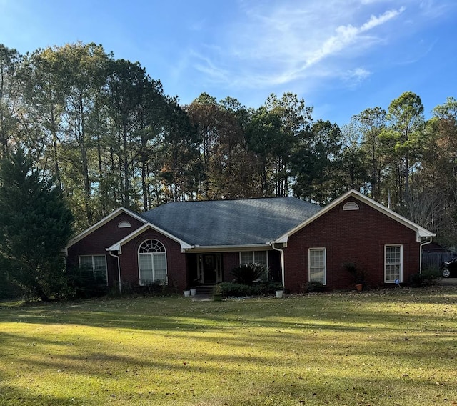 ranch-style home featuring a front lawn