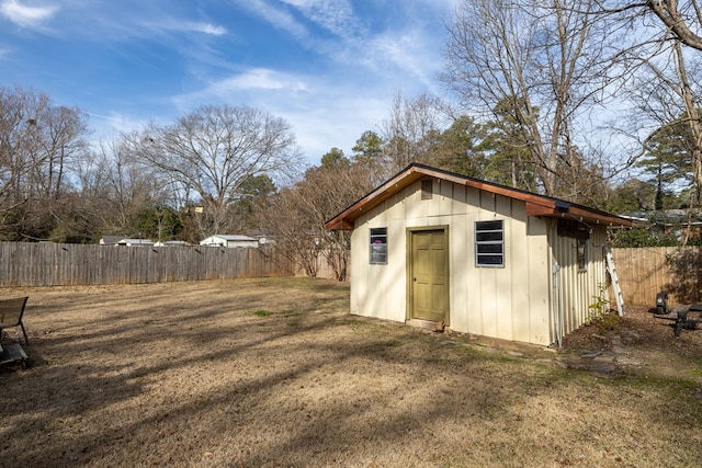 view of outbuilding featuring fence and an outdoor structure