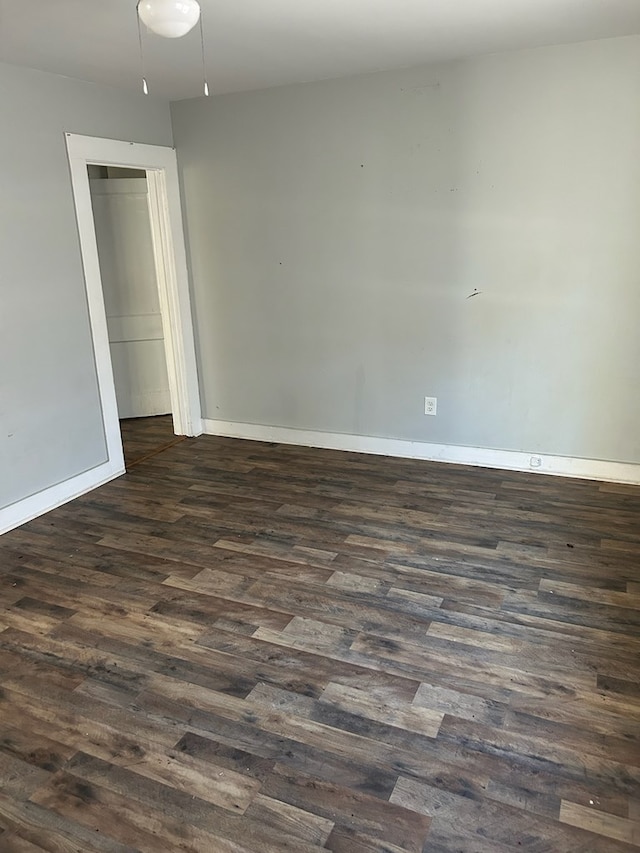 unfurnished room with dark hardwood / wood-style flooring