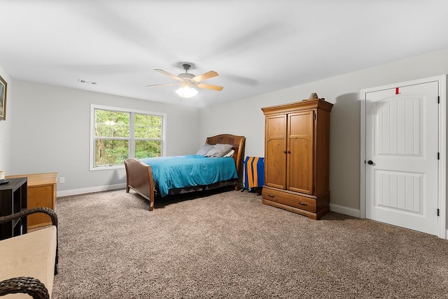 bedroom with a ceiling fan, carpet flooring, visible vents, and baseboards