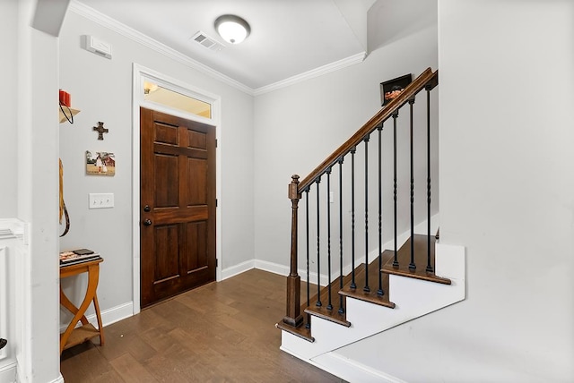 foyer with visible vents, baseboards, stairs, dark wood-style floors, and crown molding