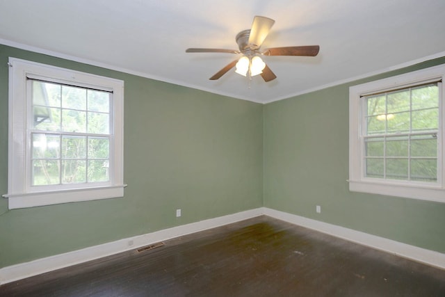 unfurnished room featuring baseboards, dark wood finished floors, ornamental molding, and ceiling fan