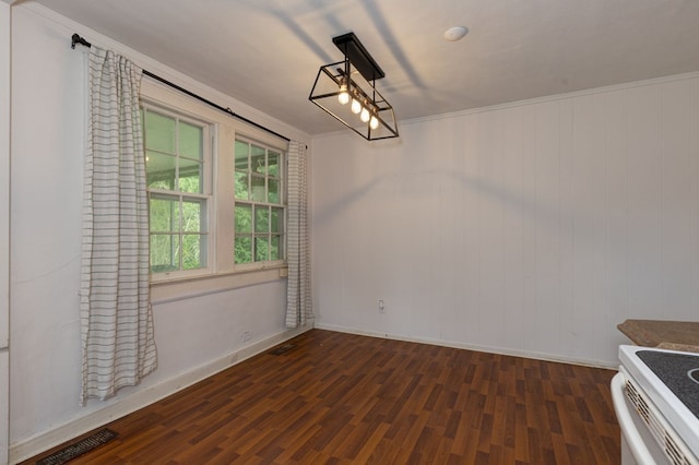 unfurnished dining area featuring dark wood finished floors and baseboards
