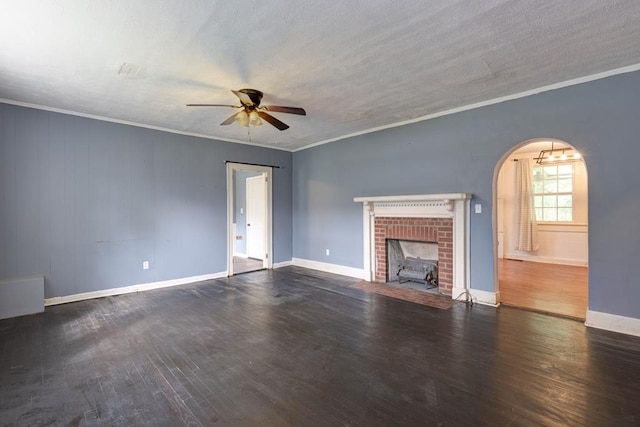 unfurnished living room featuring ceiling fan, wood finished floors, baseboards, crown molding, and arched walkways