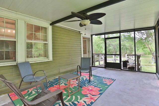 sunroom / solarium featuring ceiling fan