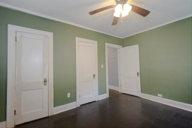 unfurnished bedroom with wood finished floors, ornamental molding, baseboards, and a ceiling fan