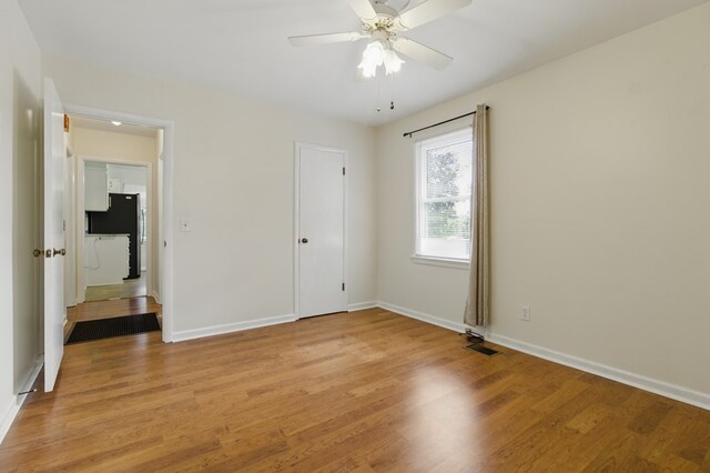 2608 5th Ave, Phenix City, AL 36867 - unfurnished bedroom featuring freestanding refrigerator, light wood-style floors, baseboards, and a ceiling fan