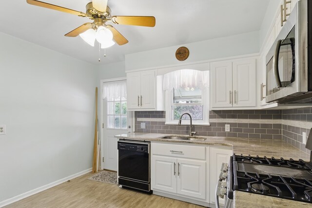 2608 5th Ave, Phenix City, AL 36867 - kitchen with black dishwasher, stainless steel microwave, a sink, and tasteful backsplash