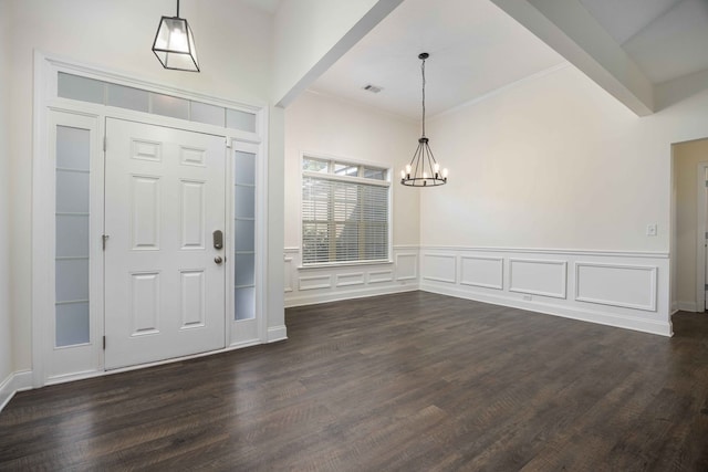1170 Railroad Ave, Smiths Station, AL 36877 - foyer featuring a chandelier, dark wood-style floors, a wainscoted wall, and a decorative wall