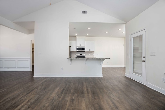 1170 Railroad Ave, Smiths Station, AL 36877 - kitchen featuring appliances with stainless steel finishes, a kitchen bar, light stone counters, white cabinets, and a peninsula
