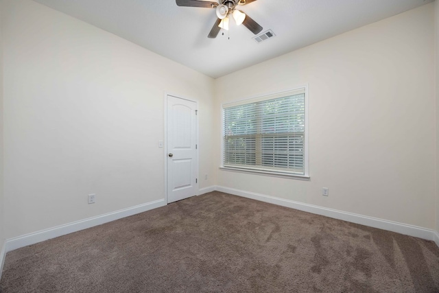 1170 Railroad Ave, Smiths Station, AL 36877 - empty room with dark colored carpet, ceiling fan, and baseboards