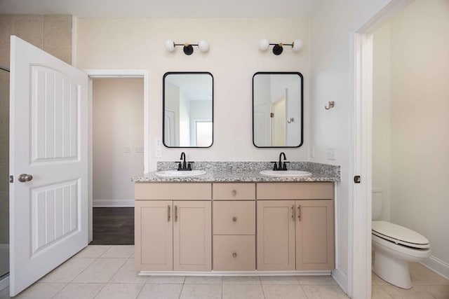 1170 Railroad Ave, Smiths Station, AL 36877 - bathroom featuring double vanity, toilet, tile patterned floors, and baseboards