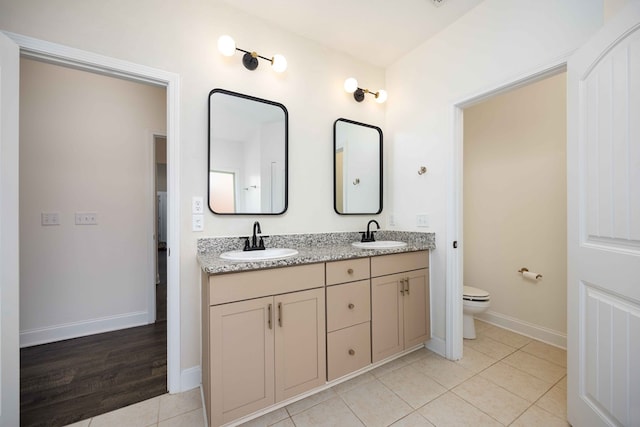 1170 Railroad Ave, Smiths Station, AL 36877 - full bathroom featuring double vanity, tile patterned floors, toilet, and baseboards