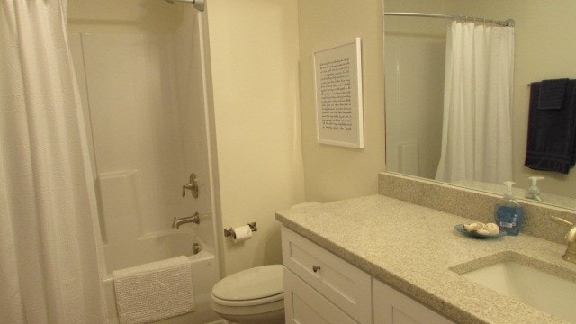 full bathroom with vanity, toilet, and shower / bath combo with shower curtain