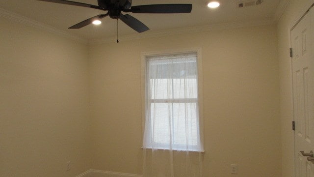 unfurnished room with ceiling fan, ornamental molding, and a wealth of natural light