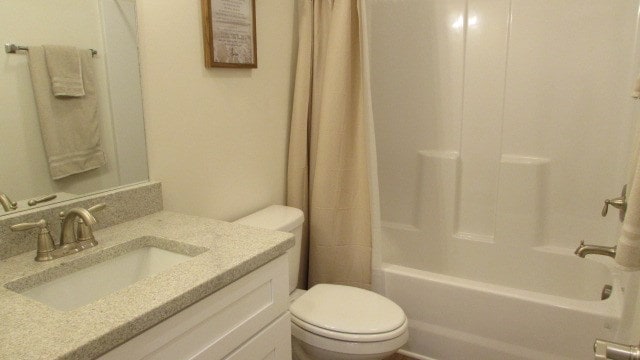 full bathroom with vanity, toilet, and shower / bath combo with shower curtain