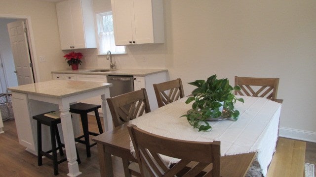 dining area with wood-type flooring and sink