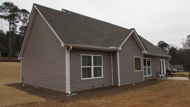 view of property exterior featuring a lawn