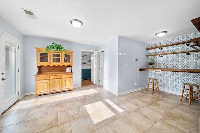 3796 Auburn Rd, Phenix City, AL 36870 - unfurnished dining area with baseboards and wallpapered walls
