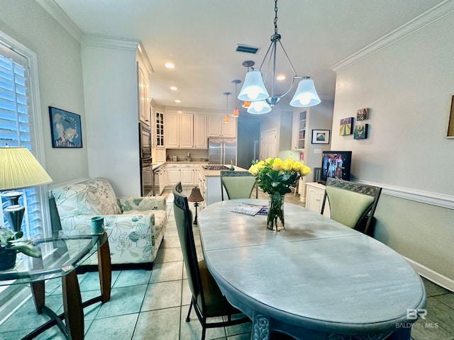 tiled dining area featuring an inviting chandelier and crown molding