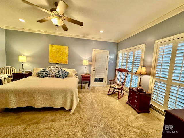 carpeted bedroom featuring ceiling fan and crown molding