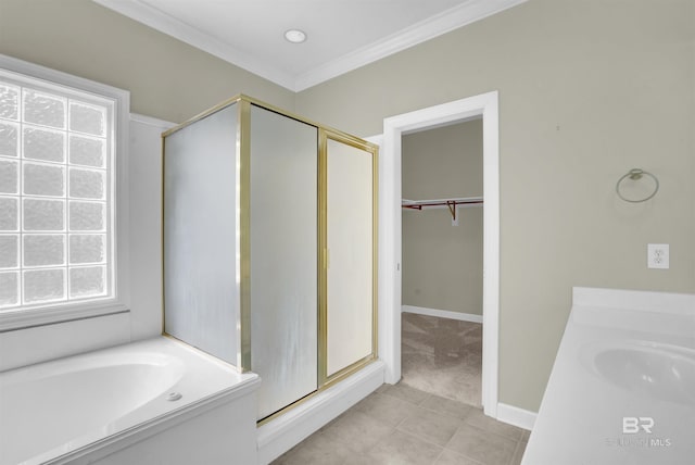 bathroom with crown molding, vanity, plus walk in shower, and tile patterned floors