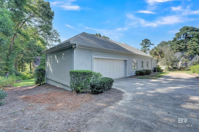 view of side of home featuring a garage