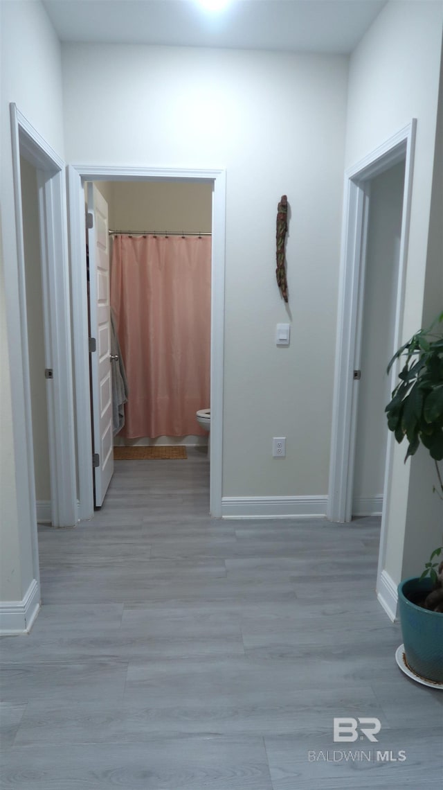 corridor featuring light hardwood / wood-style floors