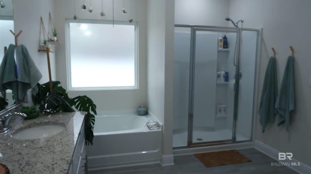 bathroom featuring vanity and separate shower and tub