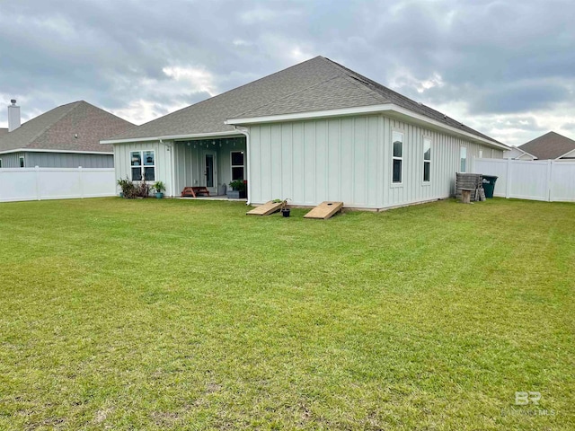 rear view of property with a lawn