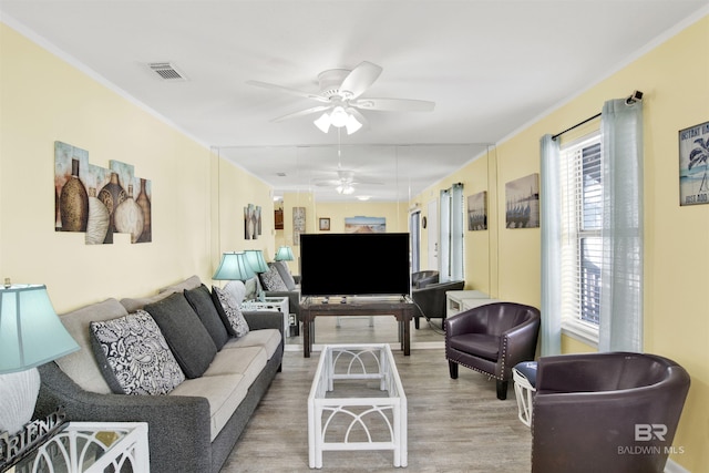 living room featuring hardwood / wood-style floors and ceiling fan