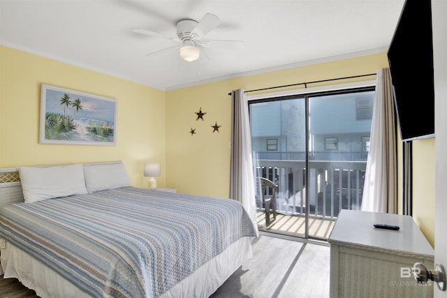 bedroom featuring hardwood / wood-style flooring, ornamental molding, multiple windows, and access to outside