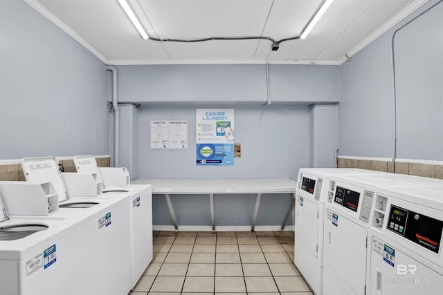 washroom featuring light tile patterned floors and washer and clothes dryer