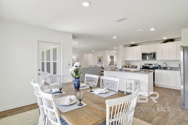 14304 State Highway 104, Silverhill, AL 36576 - dining room with light wood-style flooring and recessed lighting