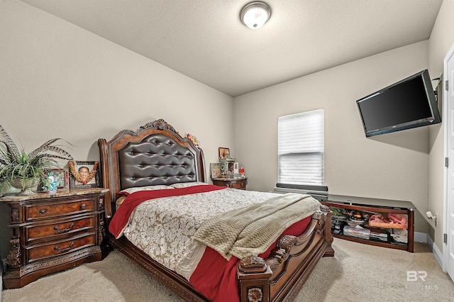 carpeted bedroom featuring a textured ceiling