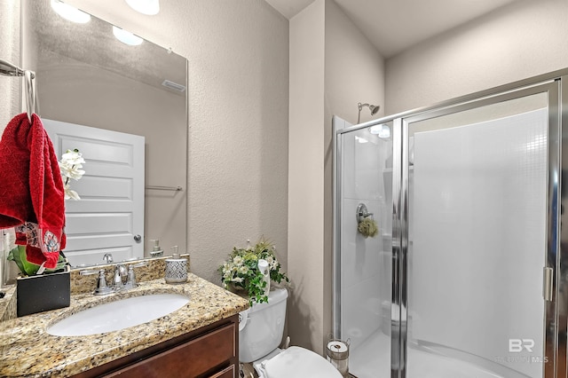 bathroom with vanity, toilet, and walk in shower