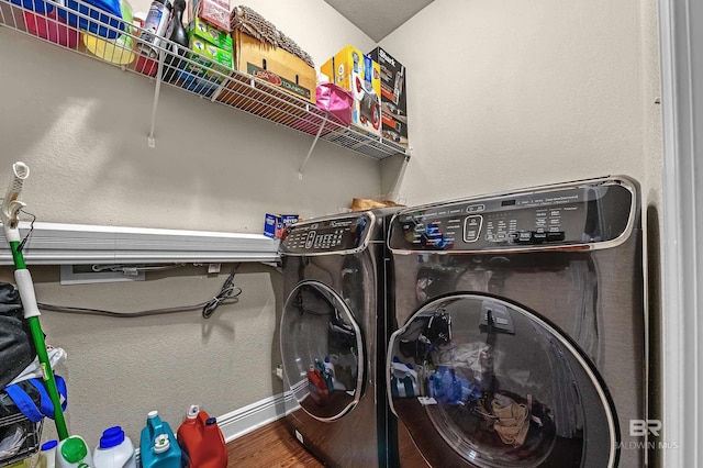 laundry area featuring washer and dryer and wood-type flooring