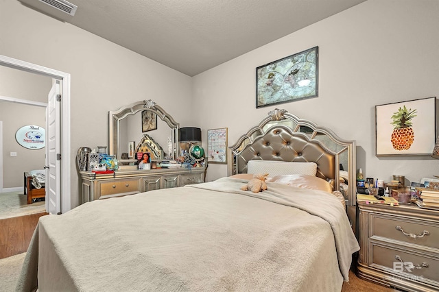 carpeted bedroom with a textured ceiling