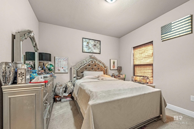 bedroom with a textured ceiling and carpet flooring