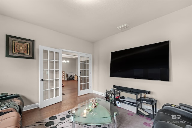 living room featuring french doors and hardwood / wood-style floors